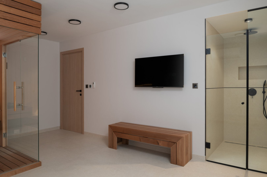 There’s also a exercise bike, a TV, and shower, along with laundry facilities that include a washing machine and dryer.