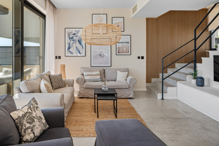 Living area complete with contemporary furnishings and large windows with sea view