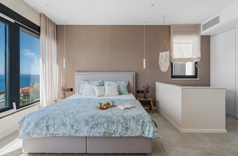 Bedroom NO1 with a king-size bed 180cm ×200cm, A/C, TV  with a view of the sea.