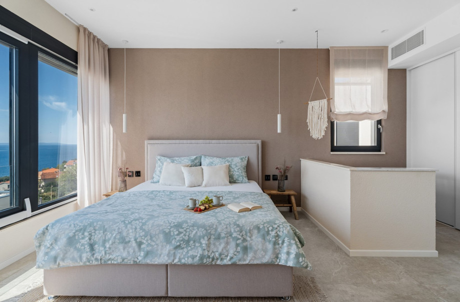 Bedroom NO1 with a king-size bed 180cm ×200cm, A/C, TV  with a view of the sea.