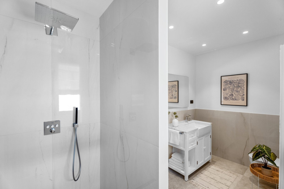 A family bathroom with a shower and a toilet