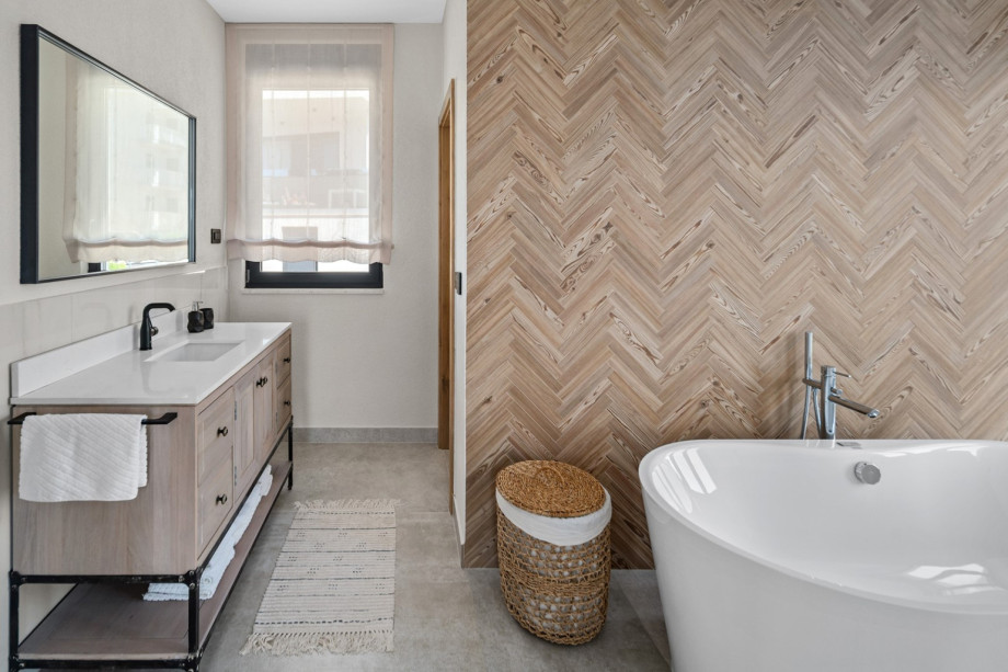 The bathroom features a walk-in shower, sink, toilet, and a luxurious self-standing bathtub.