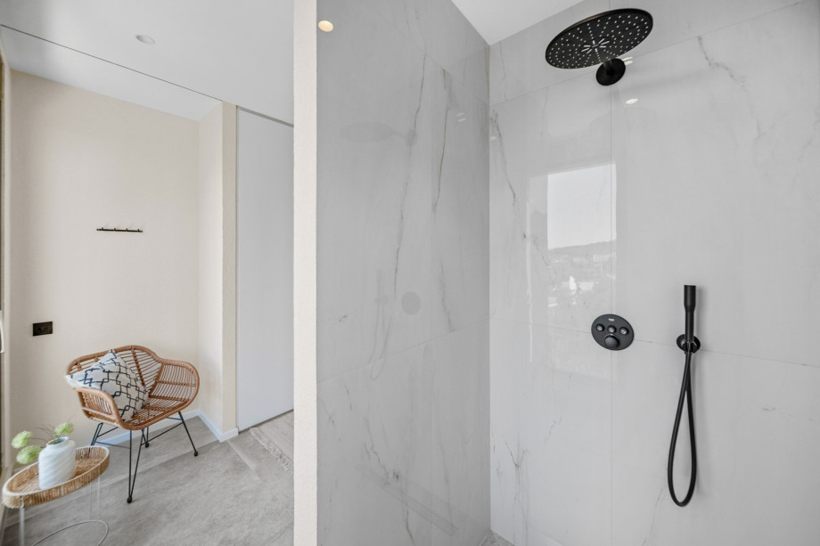 A family bathroom  with a shower and a toilet.