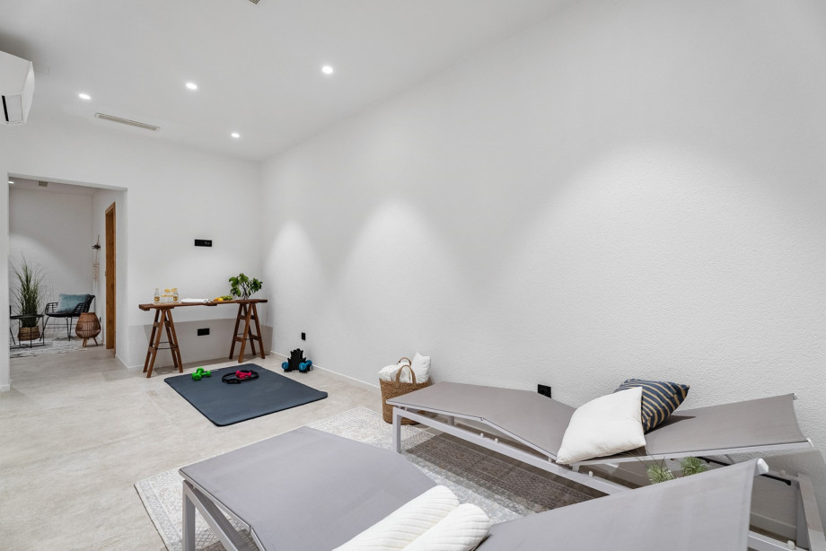 The basement offers a luxurious retreat for your wellness routine, with a Finnish sauna and yoga mats.