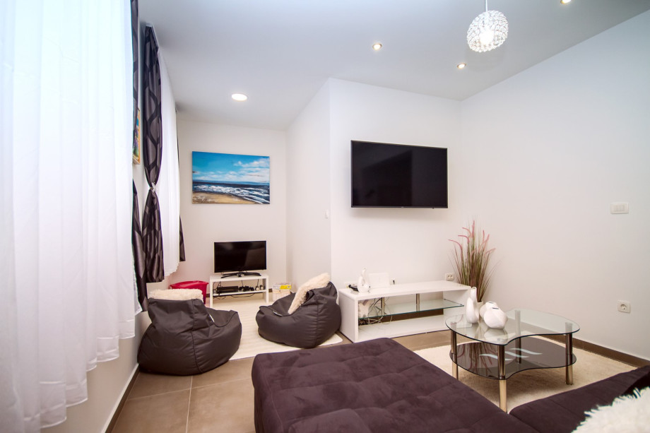 Living area with additional TV and PS, a corner for older kids :)