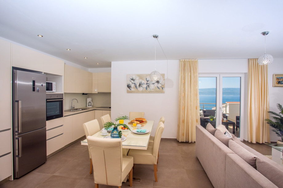 Kitchen with dining and living area on the 1st floor, balcony