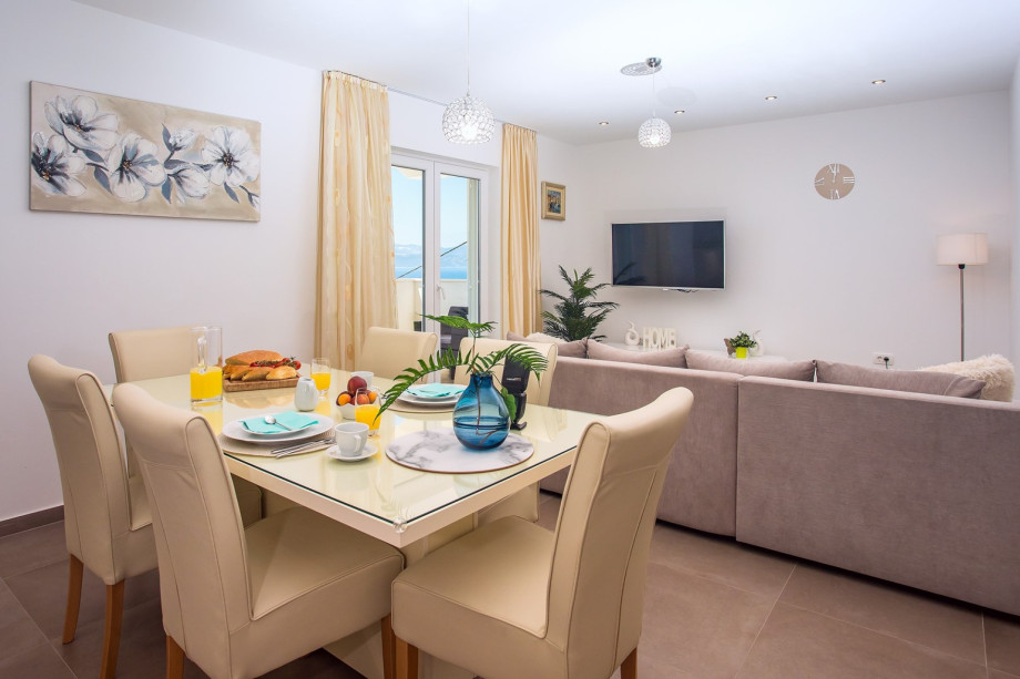 Kitchen with dining and living area on the 1st floor, balcony