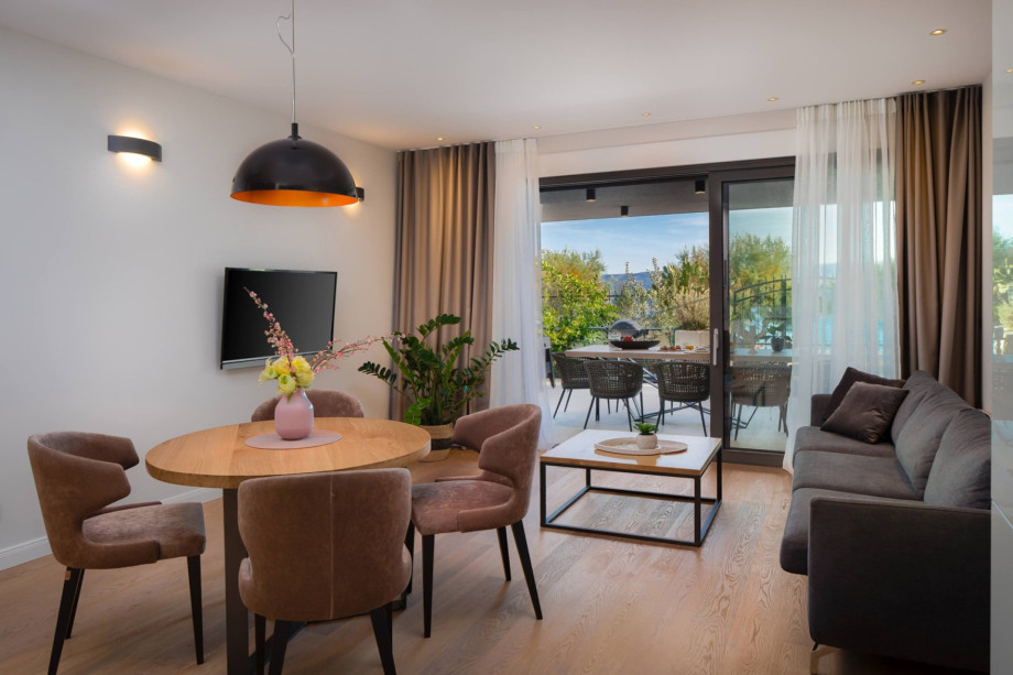 Living and dining area with fully equipped kitchen on the ground floor next to outdoor dining area