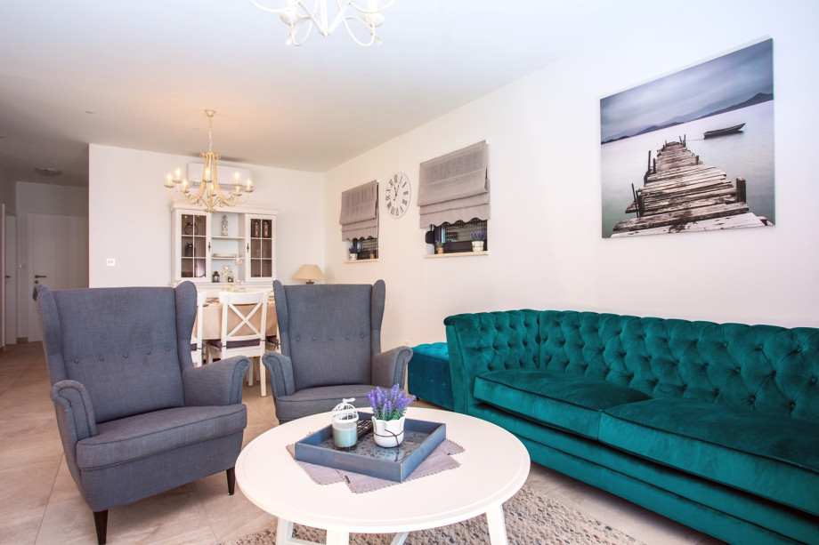 Living area with glass walls toward pool area and amazing sea views