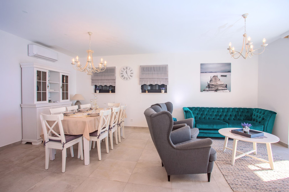 Dining and living area with sea and pool views
