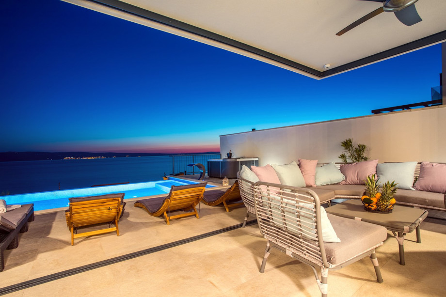 Opened sea and island views in the evening where you see lights on island Brač