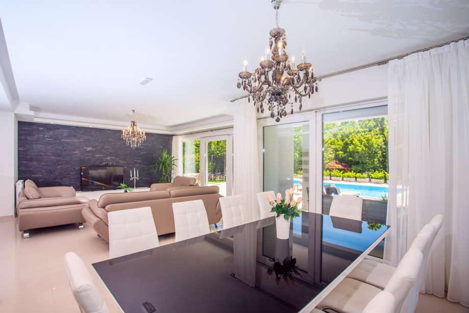 Very comfortable, air-conditioned living room with comfy sofas and a dining area