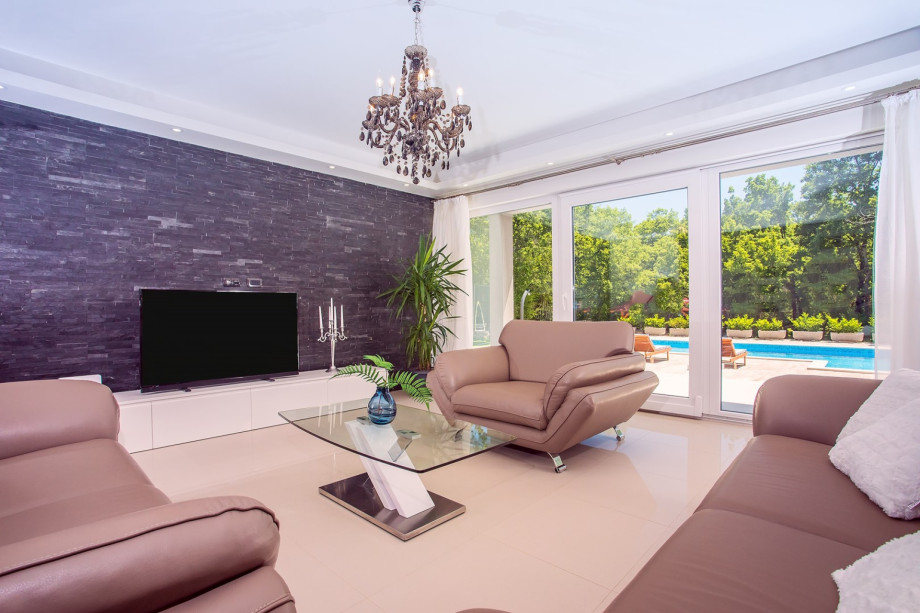 Very comfortable, air-conditioned living room with comfy sofas and a dining area