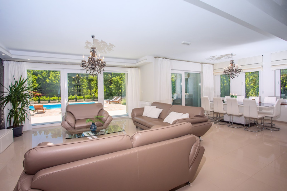 Very comfortable, air-conditioned living room with comfy sofas and a dining area