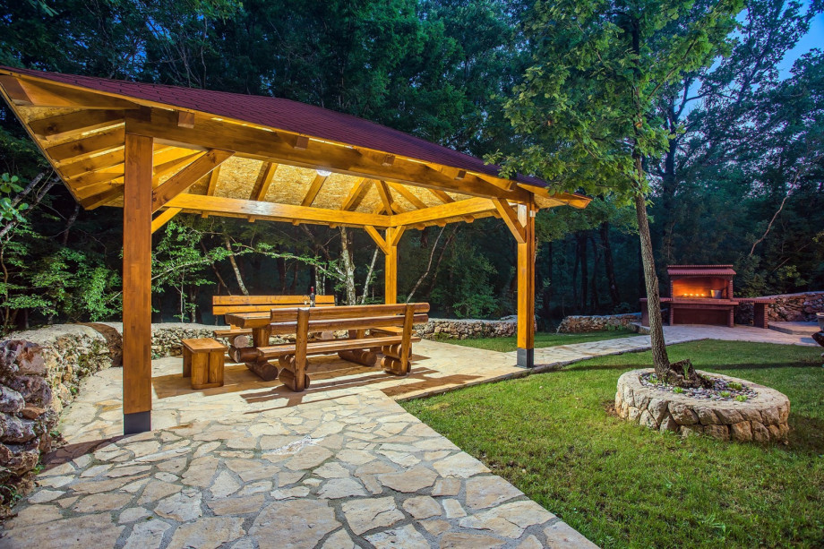 Covered  outdoor dining area for 12 people with traditional BBQ