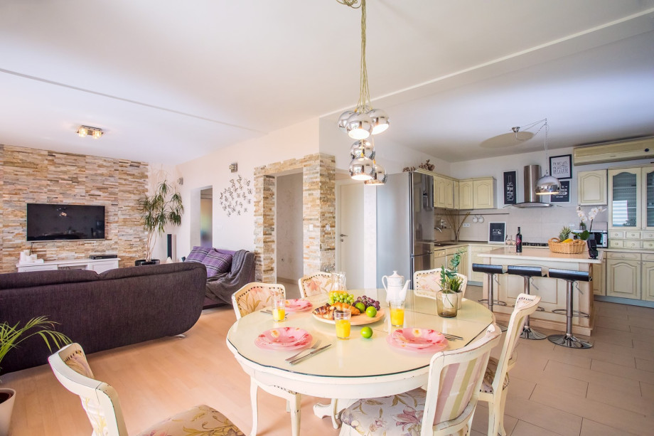 The first-floor offers an air-conditioned living and dining room with a kitchen