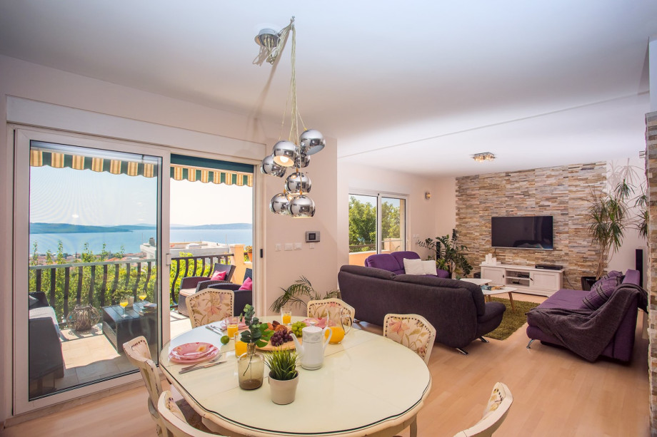 The living room is equipped with TV and PS4 and exit to the balcony.