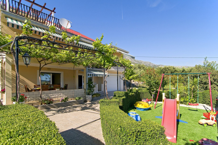 There are two grassplot areas and offers swing, slide and some toys.