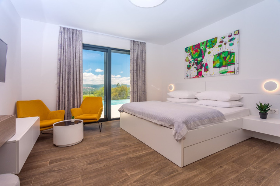 Bedroom No1 with super king size bed 200x210, TV and ensuite bathroom with shower, and direct exit to the outdoor pool area.