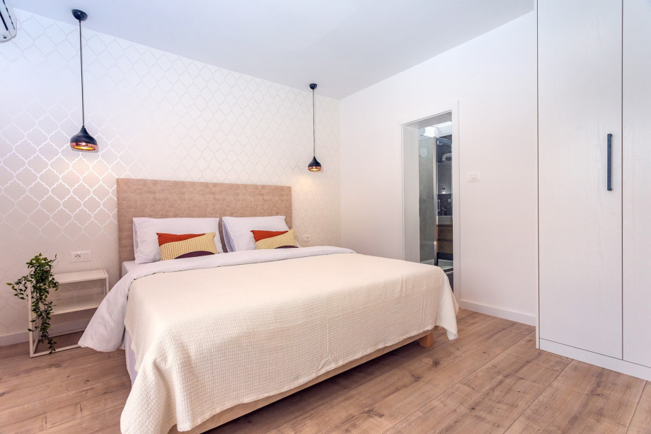 Bedroom No1 has exit to the balcony with mountain and pool views.