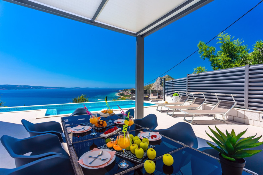 Spacious dining area in front of the summer kitchen.