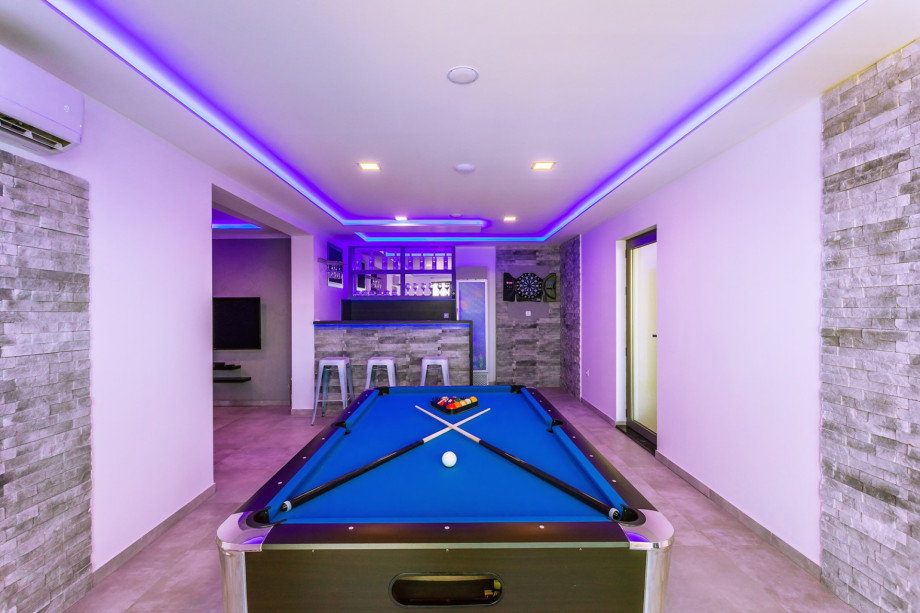 Fun Zone with a Pool table and  kitchen with bar in a lower ground floor