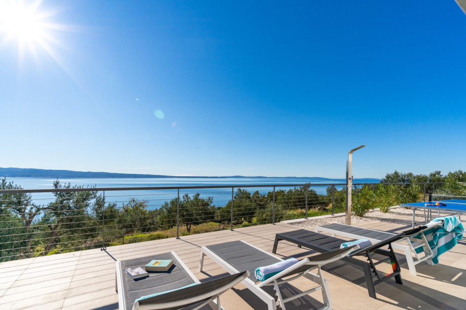 A sun deck area with 8 deck chairs