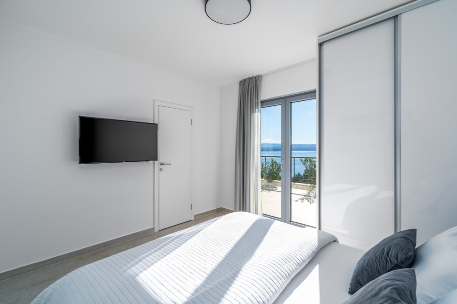 Bedroom No1 has an exit toward outdoor sundeck and pool area