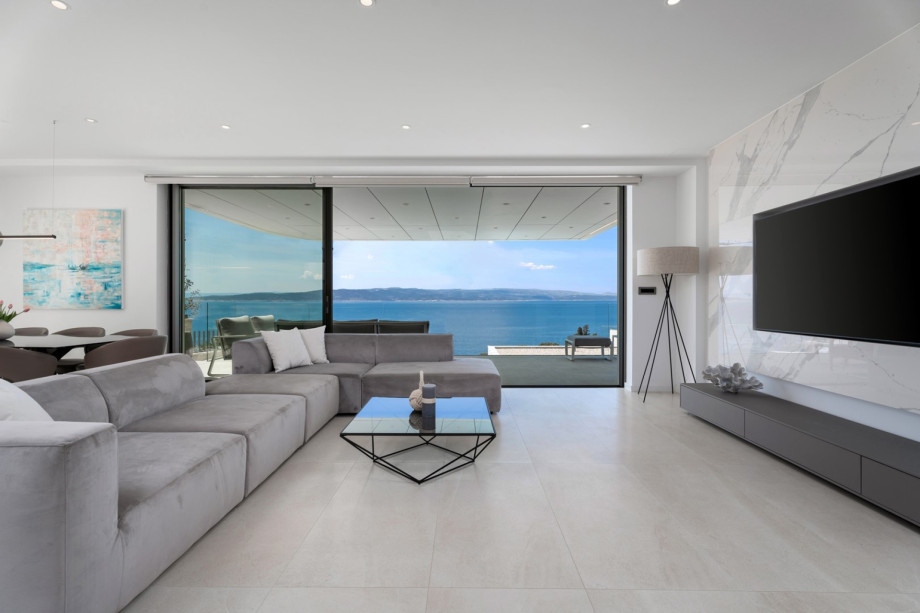 Living room offers comfortable sofa with flat screen TV, PlayStation 5, Bluetooth speakers, a Netflix, Spotify, and more