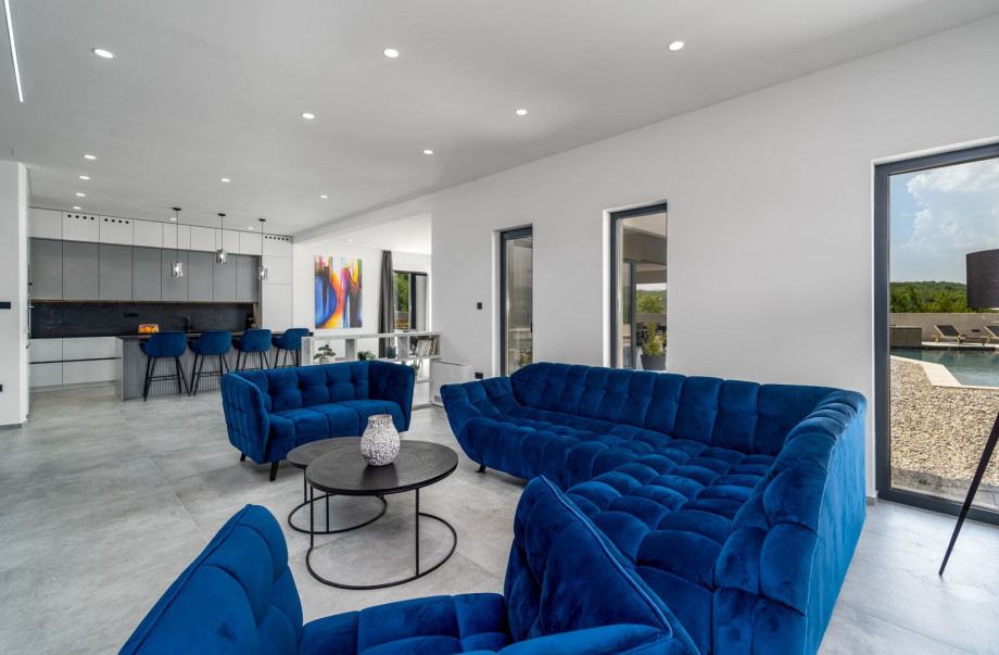 The living area is 104sqm and offers a comfortable living room, A/C, a dining area, and kitchen.