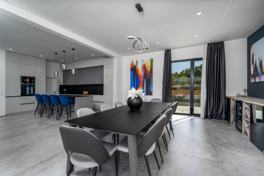 There is a direct approach to the outdoor dining area and pool area from the indoors.