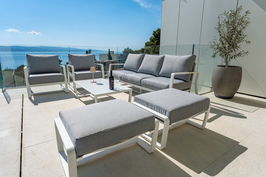 At the pool level is a covered deck area with a lounge corner