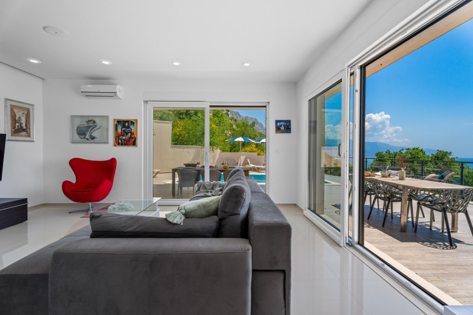 An outdoor dining area is approachable directly from the kitchen and from the living area.