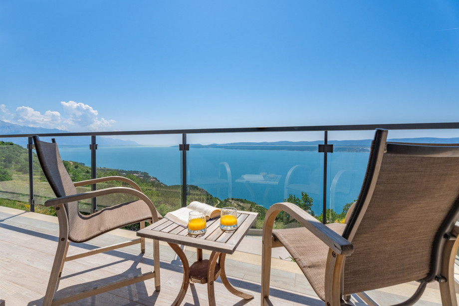 A stunning outdoor space with comfortable furniture and a breathtaking view.