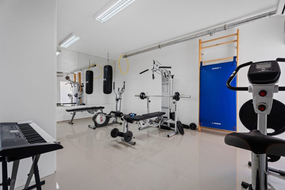 Air-conditioned gym with an exercise bike, Orbitrack, weights, and sauna