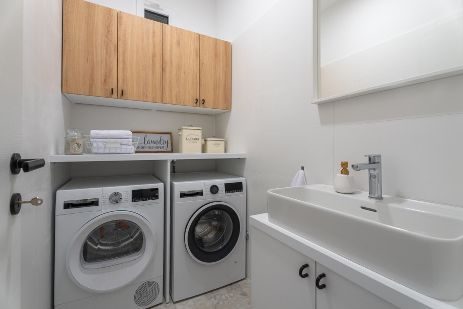 A laundry room with a dryer and washing machine