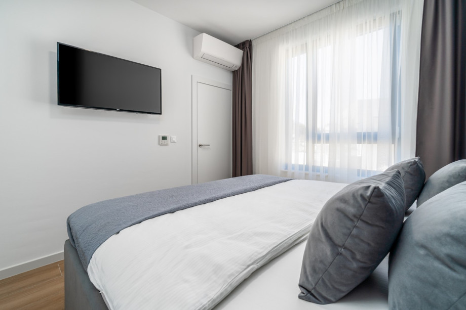 Bedroom No4 (North-West) with a king-size bed 180cm x 200cm, a TV, and Air-conditioning.