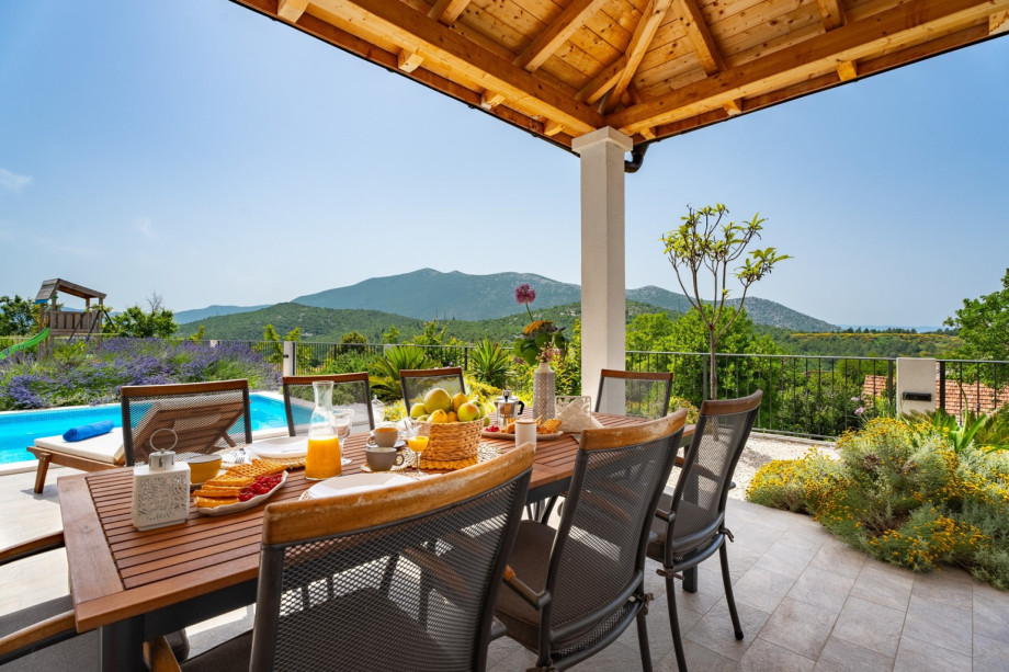 Villa Belina offers heated pool and outdoor dining area with BBQ.