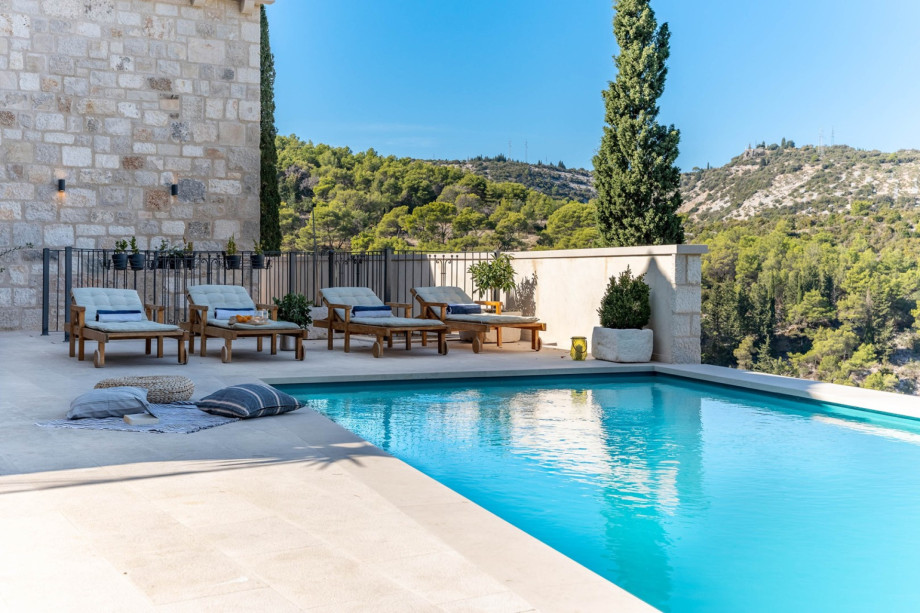 Sundeck area with 4 sundeck chairs,with sea and pool views.