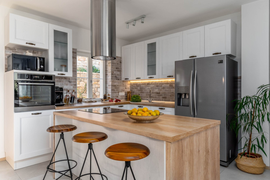 Kitchen with a pool view, and a sea view.