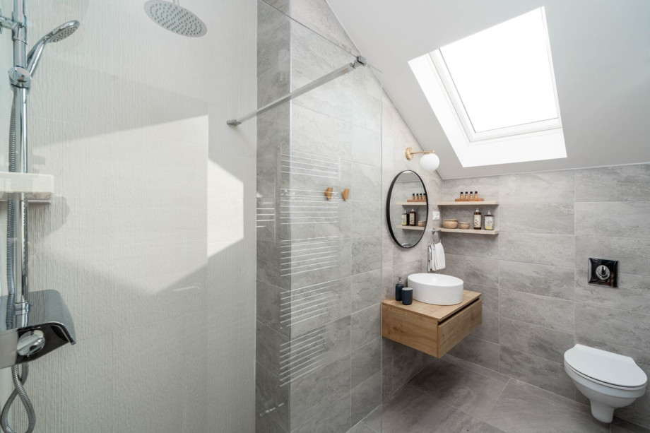 En-suite bathroom with shower and a toilet.