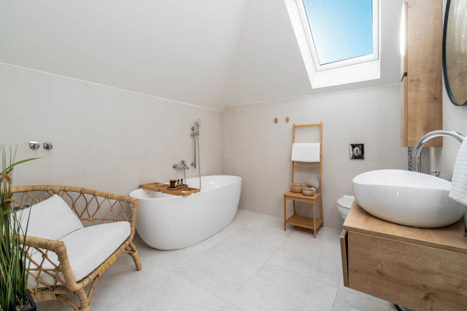Family bathroom on the first floor with a self standing bath tub, a sink, and a toilet.