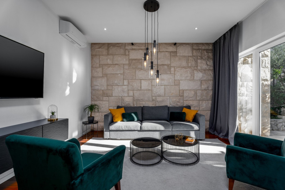 From the living room, you have a glass door toward the outdoor lounge corner and dining area.