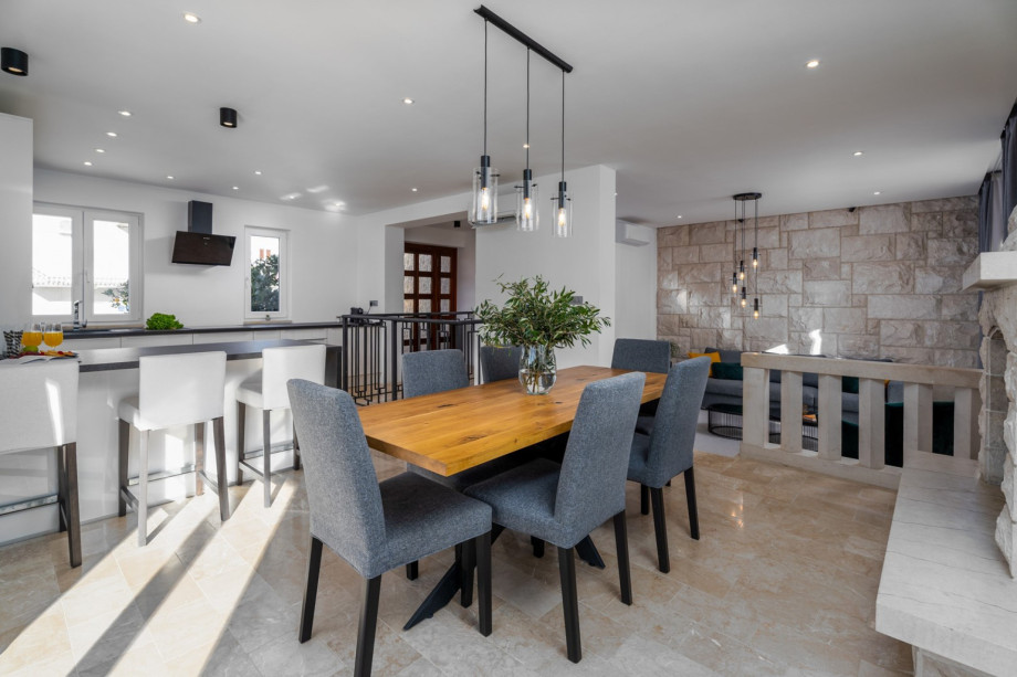 A spacious dining area, and a living room with a flat-screen TV .