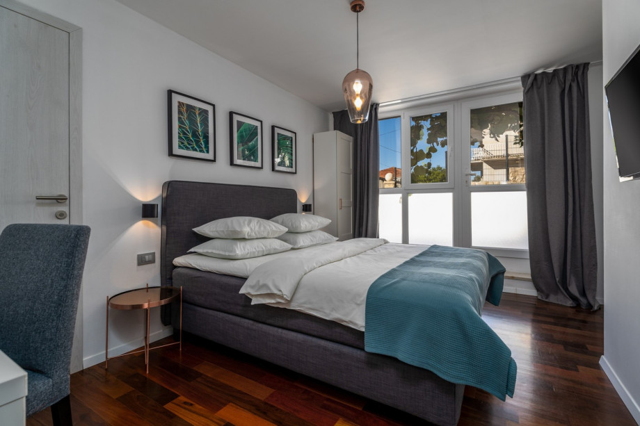 Bedroom No4 (13sqm) with a queen size bed 160cm x 200cm, air-conditioning, and a TV.