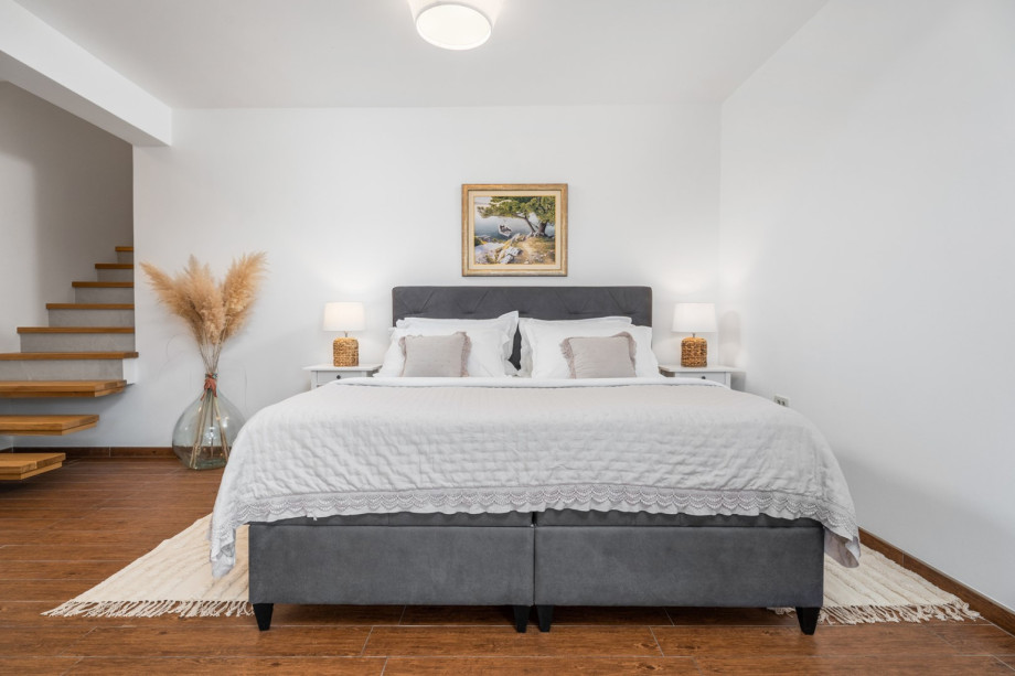 The bedroom area offers a king-size bed 180cm x 200cm, a sofa ,an air-conditioner, a TV, and a bathroom with a shower