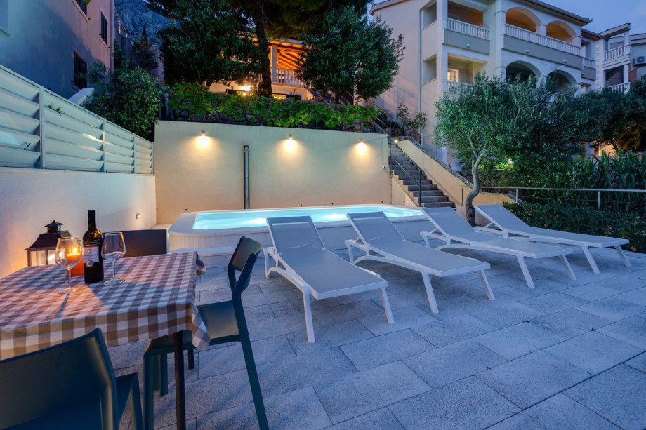 The sun deck area with 4 deck chairs and a sun umbrella