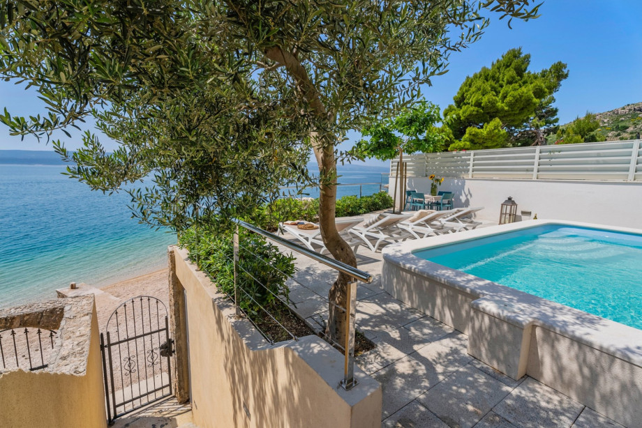 An outdoor staircase takes you to the pebble beach