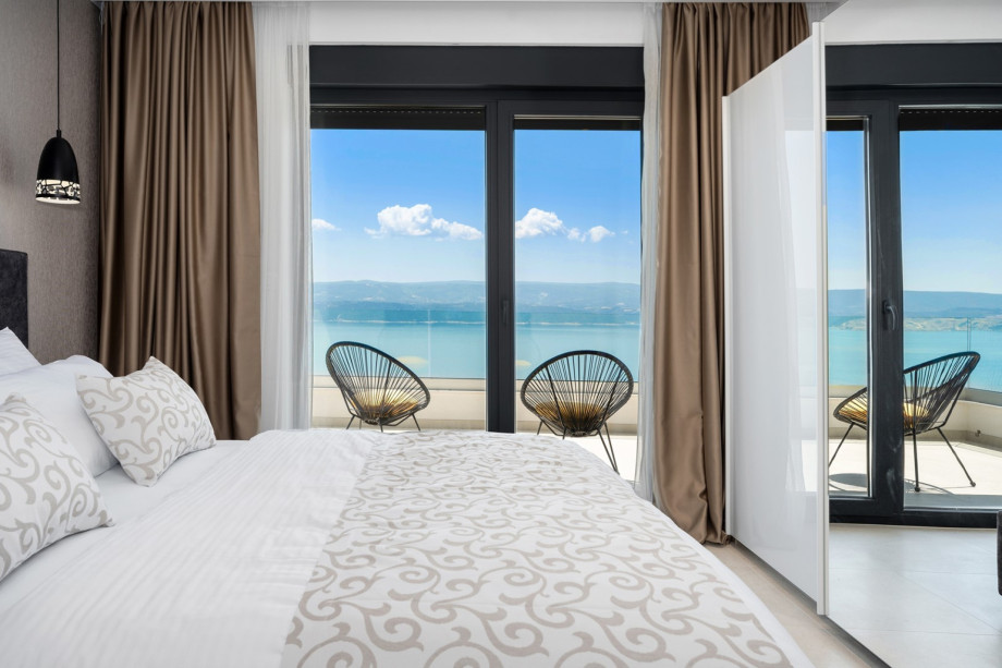 Bedroom NO4 has an exit to a terrace with outdoor furniture.