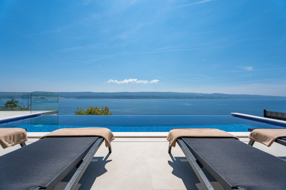 Pool area with 10 lounge chairs and shower